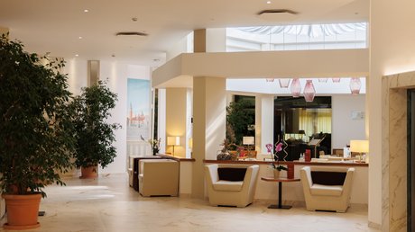 Hotel vicino ad Abano Terme a 4 stelle S: impressioni Interno moderno e luminoso con sedie bianche, piante e pavimento in marmo